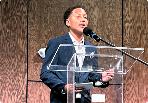 Student speaker presenting during a Tampa Organization of Black Affairs youth leadership program.
